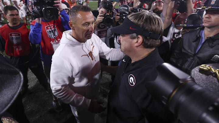 Nov 15, 2025; Athens, Georgia, USA; Texas Longhorns head coach Steve Sarkisian and Georgia Bulldogs head coach Kirby Smart interact after a game at Sanford Stadium. Mandatory Credit: Brett Davis-Imagn Images