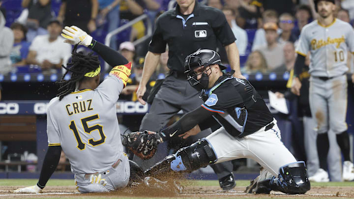 Miami, Florida, USA; Miami Marlins catcher Nick Fortes (4) tags Pittsburgh Pirates outfielder Oneil Cruz (15) at the plate during the first inning at loanDepot Park.