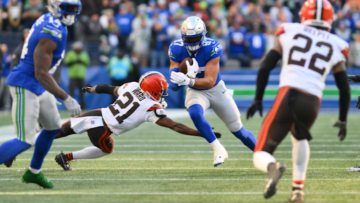 Seattle Seahawks tight end Noah Fant carries the ball past Cleveland Browns cornerback Denzel Ward.