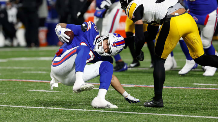 Buffalo Bills wide receiver Khalil Shakir (10) puts his hand down and regains his balance to break this tackle by Pittsburgh Steelers safety Minkah Fitzpatrick (39). Shakir finished the play for a 17 yard touchdown reception.