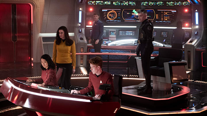 L-R Rong Fu as Mitchell, Rebecca Romijn as Una, Ethan Peck as Spock and Anson Mount as Capt. Pike in Star Trek: Strange New Worlds streaming on Paramount+, 2023. Photo Credit: Michael Gibson/Paramount+