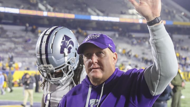 Oct 19, 2024; Morgantown, West Virginia, USA; Kansas State Wildcats head coach Chris Klieman celebrates with fans after defeating the West Virginia Mountaineers at Mountaineer Field at Milan Puskar Stadium. Mandatory Credit: Ben Queen-Imagn Images