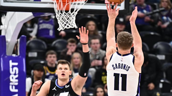 Feb 26, 2025; Salt Lake City, Utah, USA;  Sacramento Kings forward Domantas Sabonis (11) shoots over Utah Jazz center Walker Kessler (24) in the second half at Delta Center. Mandatory Credit: Jamie Sabau-Imagn Images