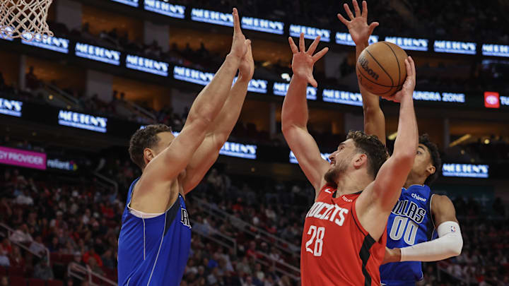 Nov 3, 2025; Houston, Texas, USA; Houston Rockets center Alperen Sengun (28) dunks against Dallas Mavericks forward Dwight Powell (7) in the second quarter at Toyota Center. Mandatory Credit: Thomas Shea-Imagn Images
