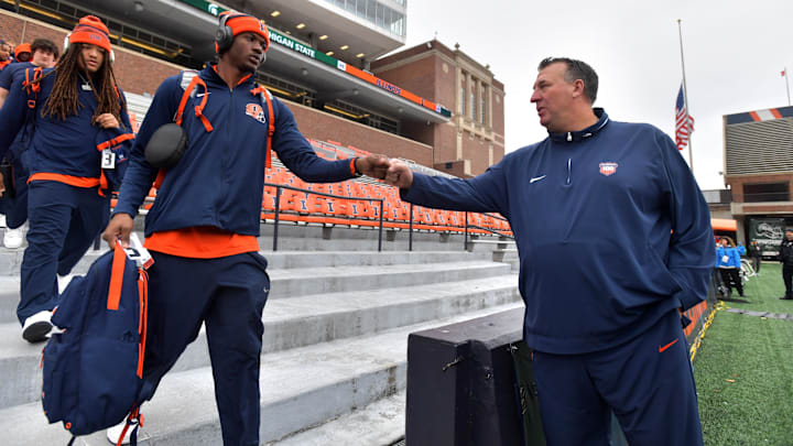 Nov 16, 2024; Champaign, Illinois, USA; Illinois Fighting Illini head coach Bret Bielema gives a hand to players before the game against the Michigan State Spartans at Memorial Stadium. Mandatory Credit: Ron Johnson-Imagn Images Nov 16, 2024; Champaign, Illinois, USA; Illinois Fighting Illini head coach Bret Bielema gives a hand to players before the game against the Michigan State Spartans at Memorial Stadium. Mandatory Credit: Ron Johnson-Imagn Images