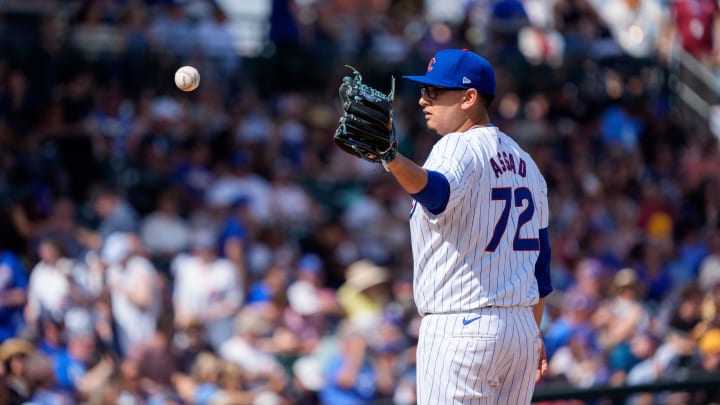 Feb 25, 2024; Mesa, Arizona, USA; Chicago Cubs pitcher Javier Assad (72) reaches out to catch a ball