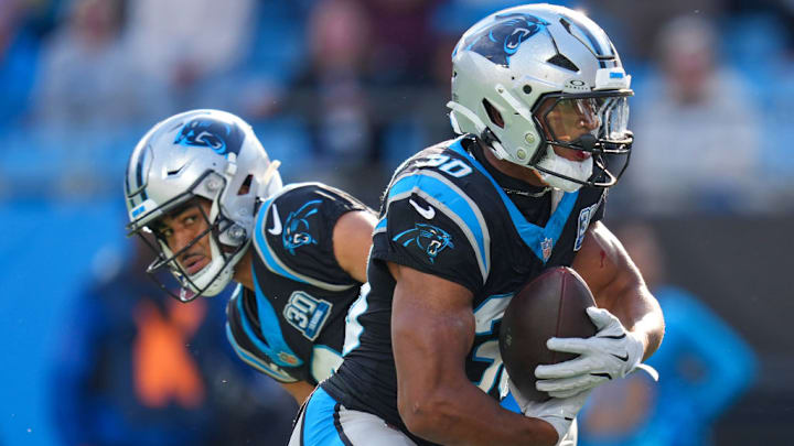 CHARLOTTE, NORTH CAROLINA - NOVEMBER 03: Bryce Young #9 of the Carolina Panthers hands the ball off to Chuba Hubbard #30 of the Carolina Panthers during the third quarter at Bank of America Stadium on November 03, 2024 in Charlotte, North Carolina. CHARLOTTE, NORTH CAROLINA - NOVEMBER 03: Bryce Young #9 of the Carolina Panthers hands the ball off to Chuba Hubbard #30 of the Carolina Panthers during the third quarter at Bank of America Stadium on November 03, 2024 in Charlotte, North Carolina.