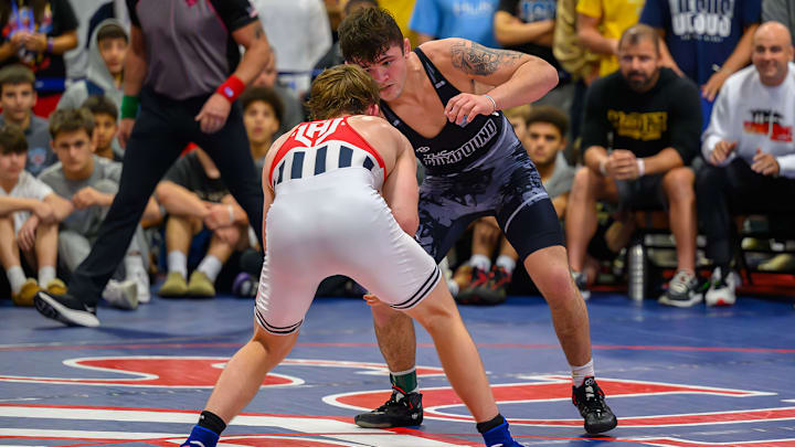 Bo Bassett sizes up Florida's Charlie Desena in the 150-pound Super 32 final. Bassett won 13-4 to capture his fourth consecutive Super 32 title.