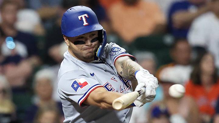 Texas Rangers second baseman Cody Freeman swings at a pitch with his bat. 
