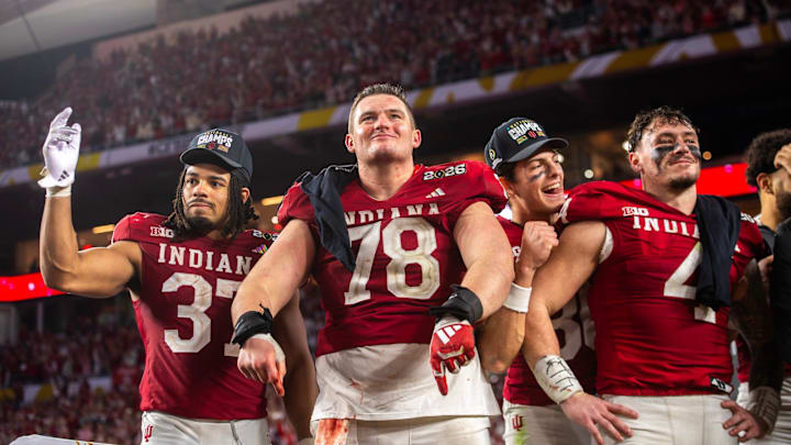 Indiana's Pat Coogan (78) celebrates his team's national title with Riley Nowakowski (37), Charlie Becker (80) and Aiden Fisher (4). Indiana's Pat Coogan (78) celebrates his team's national title with Riley Nowakowski (37), Charlie Becker (80) and Aiden Fisher (4).