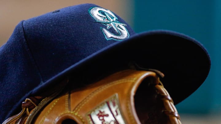 A Seattle Mariners hat sits on top a mitt during a game against the Texas Rangers in 2016 at Globe Life Field in Arlington, Texas.