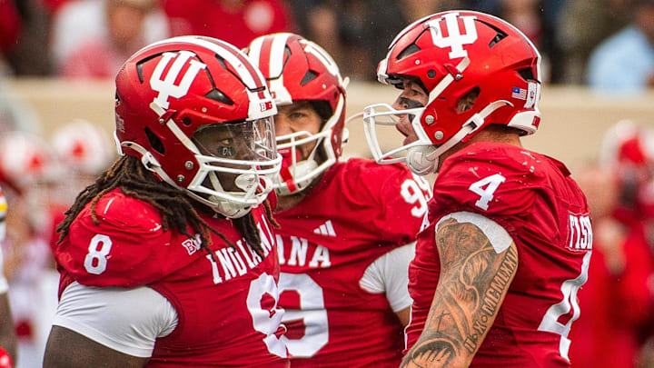 Indiana's Aiden Fisher (4) and CJ West (8) celebrate West's sack of Maryland's Billy Edwards Jr. (9) during the Indiana versus Maryland football game at Memorial Stadium on Saturday, Sept. 28, 2024.