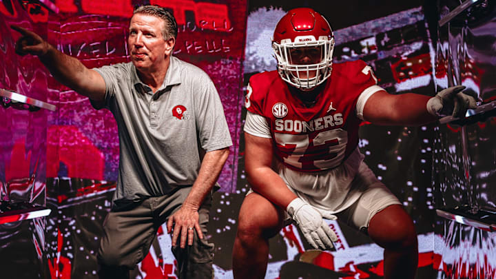 Oklahoma offensive line coach Bill Bedenbaugh and 2026 recruit Deacon Schmitt.