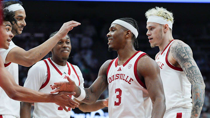 Louisville Cardinals guard Mikel Brown Jr. (0), left, celebrates with Louisville Cardinals guard Ryan Conwell (3) as Louisville Cardinals guard Adrian Wooley (14) and Louisville Cardinals forward Kasean Pryor (7) look on in the first half against NC State at the KFC Yum! Center in downtown Louisville February 9, 2026.