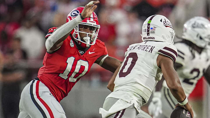 Oct 12, 2024; Athens, Georgia, USA; Georgia Bulldogs linebacker Damon Wilson II (10) tries to tackle Mississippi State Bulldogs quarterback Michael Van Buren Jr. (0) at Sanford Stadium. Mandatory Credit: Dale Zanine-Imagn Images
