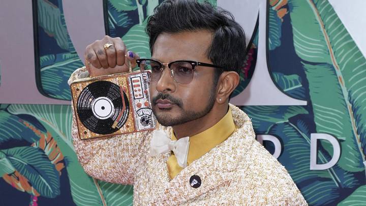 Utkarsh Ambudkar brought serious hobby heat to The Rich Eisen Show, showcasing a collection of high-end sports and pop culture cards.