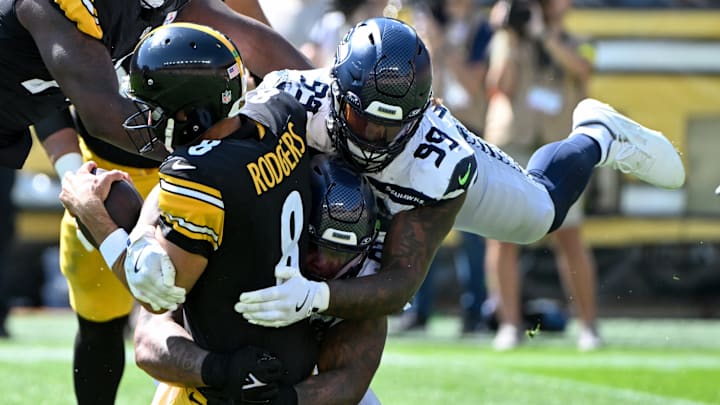 Sep 14, 2025; Pittsburgh, Pennsylvania, USA; Seattle Seahawks defensive end Leonard Williams (99) sacks Pittsburgh Steelers quarterback Aaron Rodgers (8) during the second quarter at Acrisure Stadium.