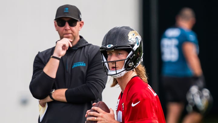 Jacksonville Jaguars quarterback Trevor Lawrence (16) falls back as Jacksonville Jaguars head coach Liam Coen watches during the Jacksonville Jaguars’ mandatory minicamp Tuesday June 10, 2025 at the Miller Electric Center in Jacksonville, Fla. 