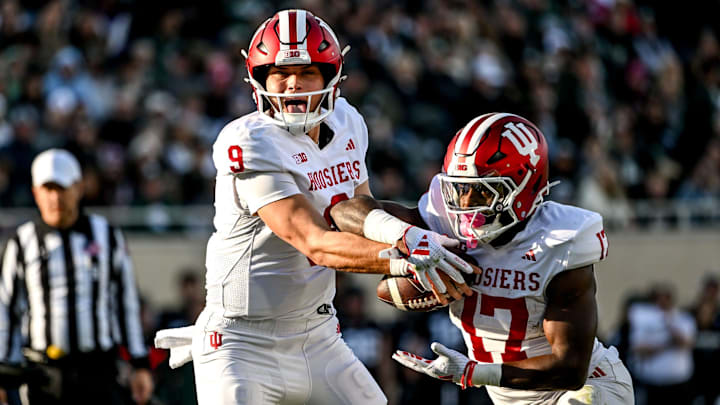 Indiana's Kurtis Rourke, left, hands the ball off to Ty Son Lawton during the second quarter on Saturday, Nov. 2, 2024, at Spartan Stadium in East Lansing.