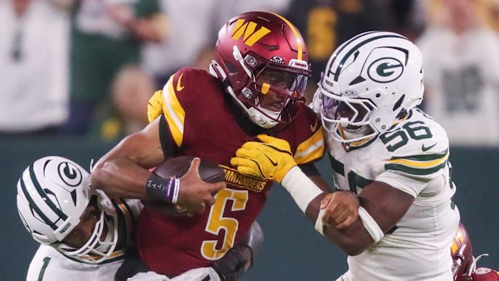 Packers DE Micah Parsons (1) and LB Edgerrin Cooper (56) sack Washington Commanders quarterback Jayden Daniels.