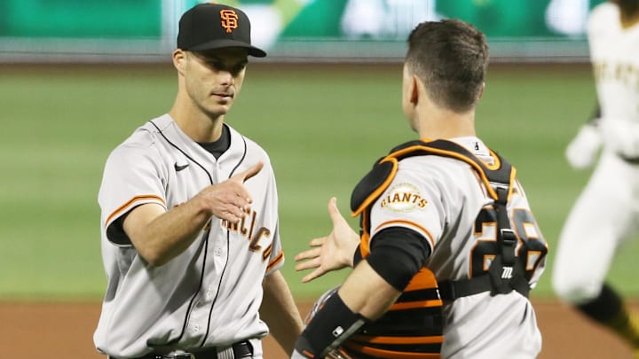 May 13, 2021; Pittsburgh, Pennsylvania, USA; San Francisco Giants relief pitcher Tyler Rogers (L) and catcher Buster Posey (28) shake hands after defeating the Pittsburgh Pirates at PNC Park. Mandatory Credit: Charles LeClaire-Imagn Images