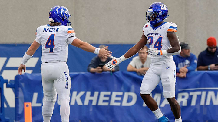 Boise State running back Dylan Riley (24) celebrates with quarterback Maddux Madsen.