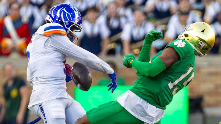 Oct 4, 2025; South Bend, Indiana, USA; Notre Dame Fighting Irish cornerback Leonard Moore (15) rips the ball away from Boise State Broncos wide receiver Chris Marshall (5) during the second half at Notre Dame Stadium. Mandatory Credit: Michael Caterina-Imagn Images