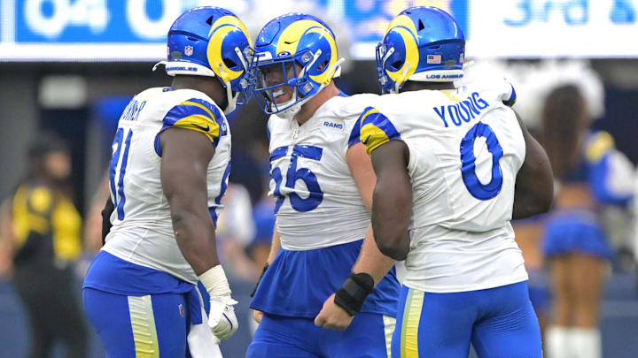 Sep 22, 2024; Inglewood, California, USA;  Los Angeles Rams defensive tackle Braden Fiske (55), defensive tackle Kobie Turner (91) and linebacker Byron Young (0) celebrate after stopping San Francisco 49ers quarterback Brock Purdy (13) in the second half at SoFi Stadium. Mandatory Credit: Jayne Kamin-Oncea-Imagn Images