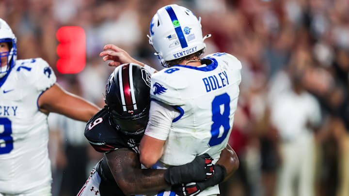 Sep 27, 2025; Columbia, South Carolina, USA; South Carolina Gamecocks linebacker Desmond Umeozulu (9) hits Kentucky Wildcats quarterback Cutter Boley (8) as he passes which causes an interception in the second quarter at Williams-Brice Stadium. Mandatory Credit: Jeff Blake-Imagn Images