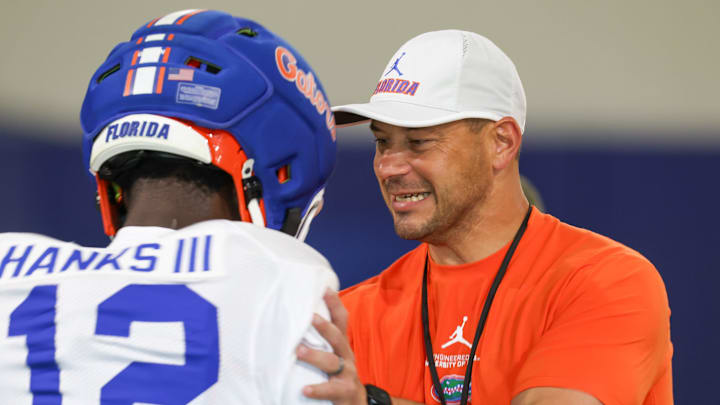 Florida Gators head coach Jon Sumrall travels between each position group during practice.