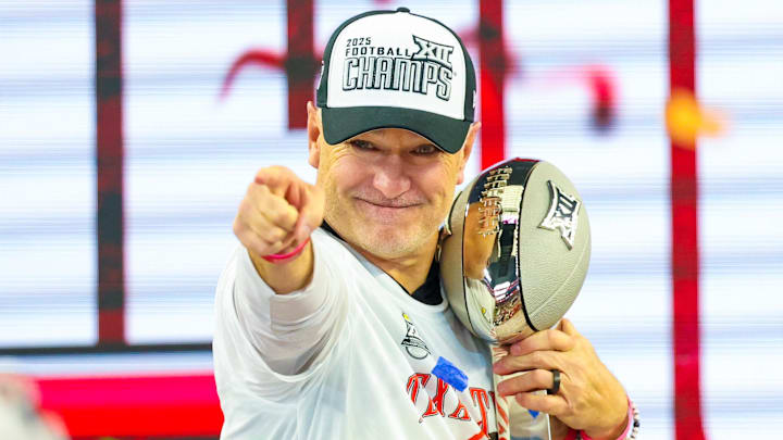 Texas Tech Red Raiders head coach Joey McGuire celebrates with the Big 12 Championship trophy after the game against the BYU Cougars at AT&T Stadium.