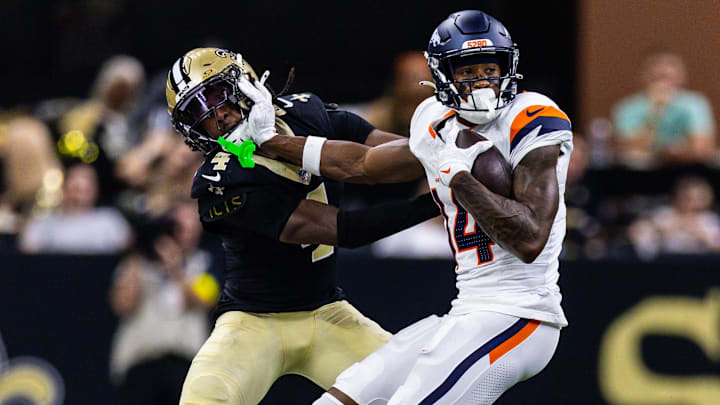 Aug 23, 2025; New Orleans, Louisiana, USA; Denver Broncos wide receiver Courtland Sutton (14) pushes away New Orleans Saints cornerback Kool-Aid McKinstry (4) during the first half at Caesars Superdome. 