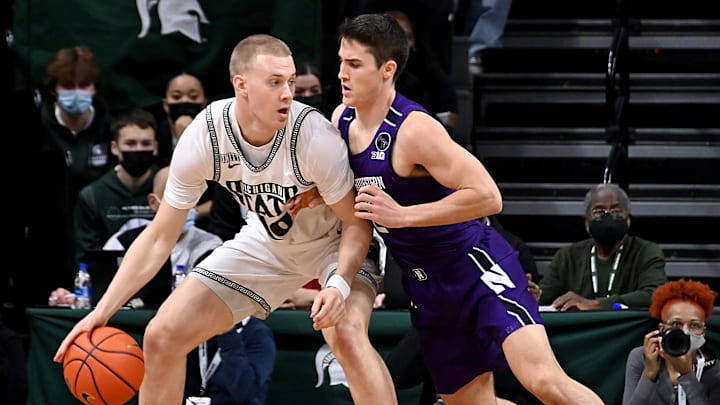 Jan 15, 2022; East Lansing, Michigan, USA;  Michigan State Spartans forward Joey Hauser (10) moves the ball against Northwestern Wildcats guard Ryan Greer (2) in the first half  at Jack Breslin Student Events Center. Mandatory Credit: Dale Young-Imagn Images