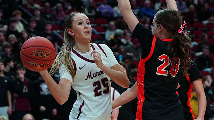 Dowling Catholic forward Ellie Muller (23) passes the ball around Valley guard Jenna Olivia Adams (20) during the third quarter in the 5A girls state quarterfinal on March 2, 2026, at Casey's Center in Des Moines, Iowa.