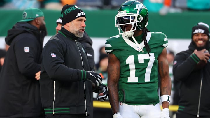 Jan 5, 2025; East Rutherford, New Jersey, USA; New York Jets interim head coach Jeff Ulbrich speaks with wide receiver Davante Adams (17) during pregame warmups for their game against the Miami Dolphins at MetLife Stadium. Mandatory Credit: Ed Mulholland-Imagn Images