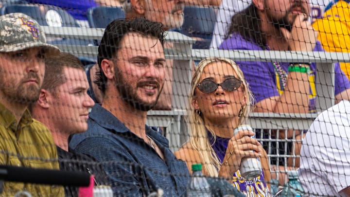 Jun 16, 2025; Omaha, Neb, USA; Paul Skenes and Livvy Dunne watch from behind home plate during the first inning between the UCLA Bruins and the LSU Tigers at Charles Schwab Field. Mandatory Credit: Dylan Widger-Imagn Images