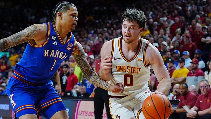Iowa State Cyclones guard Nate Heise (0) drives with the ball around Kansas Jayhawks guard Jayden Dawson (1) during the second half in the Big-12 conference basketball showdown on Feb. 14, 2026, at Hilton Coliseum, in Ames, Iowa. Iowa State Cyclones guard Nate Heise (0) drives with the ball around Kansas Jayhawks guard Jayden Dawson (1) during the second half in the Big-12 conference basketball showdown on Feb. 14, 2026, at Hilton Coliseum, in Ames, Iowa.
