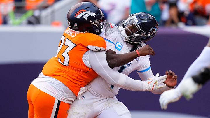 Sep 7, 2025; Denver, Colorado, USA; Denver Broncos defensive tackle D.J. Jones (93) hits Tennessee Titans quarterback Cam Ward (1) in the second half at Empower Field at Mile High. Sep 7, 2025; Denver, Colorado, USA; Denver Broncos defensive tackle D.J. Jones (93) hits Tennessee Titans quarterback Cam Ward (1) in the second half at Empower Field at Mile High.