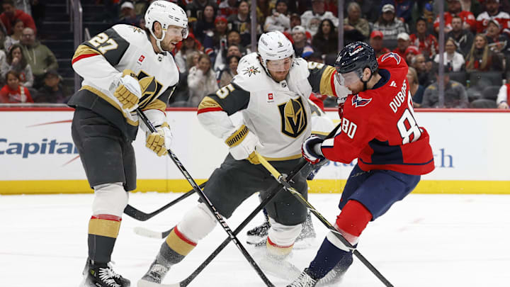 Feb 27, 2026; Washington, District of Columbia, USA; Vegas Golden Knights defenseman Jeremy Lauzon (5) and Washington Capitals left wing Pierre-Luc Dubois (80) battle for the puck during the first period at Capital One Arena. Mandatory Credit: Geoff Burke-Imagn Images Feb 27, 2026; Washington, District of Columbia, USA; Vegas Golden Knights defenseman Jeremy Lauzon (5) and Washington Capitals left wing Pierre-Luc Dubois (80) battle for the puck during the first period at Capital One Arena. Mandatory Credit: Geoff Burke-Imagn Images