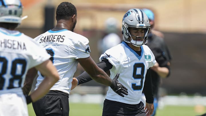 Jun 11, 2025; Charlotte, NC, USA; Carolina Panthers quarterback Bryce Young (9) high fives with Carolina Panthers tight end Ja'Tavion Sanders (0) during minicamp at Bank of America Stadium. Mandatory Credit: Jim Dedmon-Imagn Images