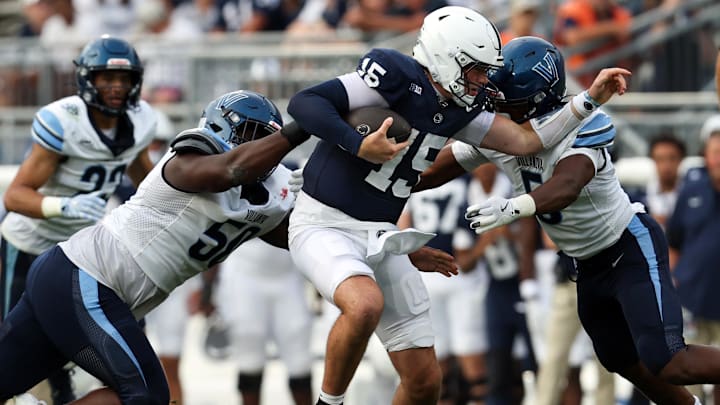 Penn State Nittany Lions quarterback Drew Allar (15) runs with the ball while trying to avoid a tackle during the third quarter against the Villanova Wildcats at Beaver Stadium. 