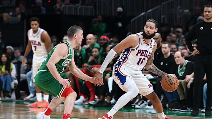 Dec 25, 2024; Boston, Massachusetts, USA; Philadelphia 76ers forward Caleb Martin (16) dribbles against Boston Celtics guard Payton Pritchard (11) during the second half at TD Garden. Mandatory Credit: Eric Canha-Imagn Images