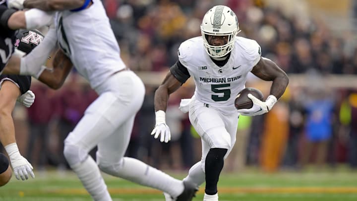 Oct 28, 2023; Minneapolis, Minnesota, USA; Michigan State Spartans running back Nate Carter (5) runs with the ball against the Minnesota Golden Gophers during the first quarter at Huntington Bank Stadium. Mandatory Credit: Nick Wosika-Imagn Images