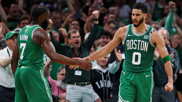 Boston Celtics forward Jayson Tatum (0) celebrates with guard Jaylen Brown.