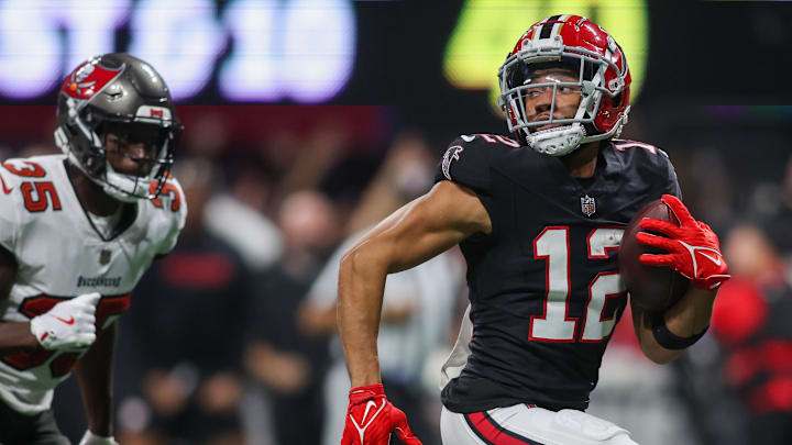 Oct 3, 2024; Atlanta, Georgia, USA; Atlanta Falcons wide receiver KhaDarel Hodge (12) runs after a catch to score the game-winning touchdown against the Tampa Bay Buccaneers in overtime at Mercedes-Benz Stadium. Mandatory Credit: Brett Davis-Imagn Images
