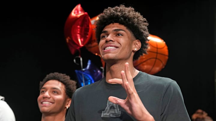 Basketball player NoNo Brown signs with Western New Mexico, left, and Koa Peat, signs with the University of Arizona during National Signing Day at Perry High School in Gilbert, Arizona on April 16, 2025.