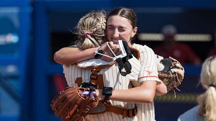 May 31, 2025; Oklahoma City, OK, USA;  Texas Longhorns pitcher Teagan Kavan (17) hugs Reese Atwood (14) after the Longhorns defeated Oklahoma Sooners 4-2 during the NCAA Softball Women's College World Series at Devon Park. Mandatory Credit: Brett Rojo-Imagn Images