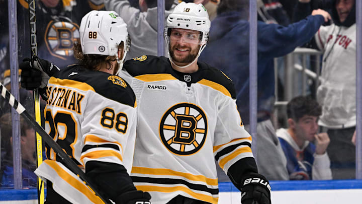 Nov 27, 2024; Elmont, New York, USA;  Boston Bruins center Pavel Zacha (18) celebrates his goal with Boston Bruins right wing David Pastrnak (88) against the New York Islanders during the third period at UBS Arena. Mandatory Credit: Dennis Schneidler-Imagn Images