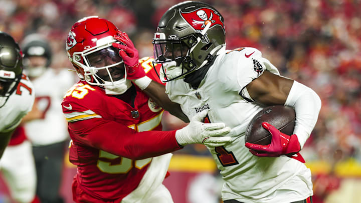 Nov 4, 2024; Kansas City, Missouri, USA; Tampa Bay Buccaneers running back Rachaad White (1) runs the ball against Kansas City Chiefs linebacker Joshua Uche (55) during the first half at GEHA Field at Arrowhead Stadium. Mandatory Credit: Jay Biggerstaff-Imagn Images