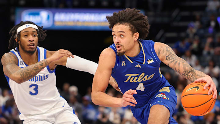 Feb 5, 2025; Memphis, Tennessee, USA; Tulsa Golden Hurricane guard Braeden Carrington (4) drives to the basket against Memphis Tigers guard Colby Rogers (3) during the second half at FedExForum. Mandatory Credit: Wesley Hale-Imagn Images